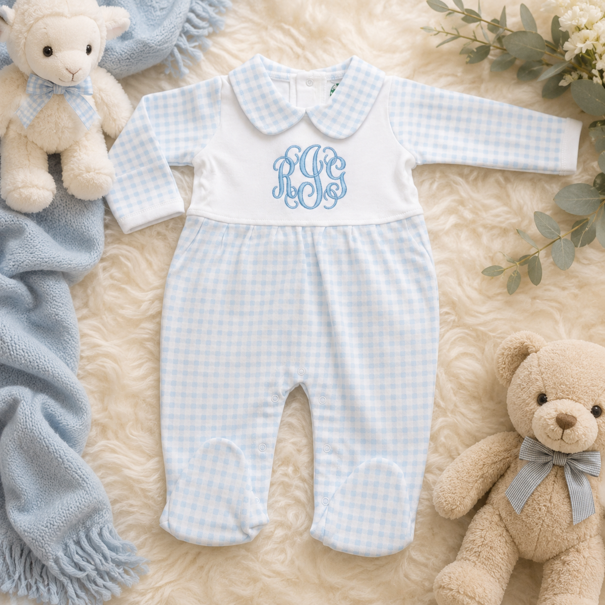 Personalized baby boy blue gingham footed sleeper featuring a custom embroidered three-letter monogram on a soft white cotton outfit with Peter Pan collar by RoJo Custom Designs.