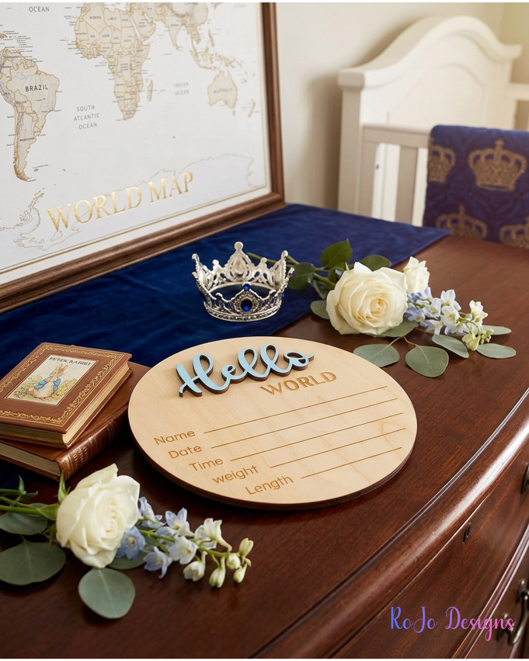 Blue Hello World wooden birth announcement sign displayed in nursery setting