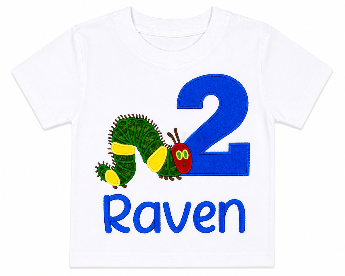 Lay-flat view of a personalized embroidered caterpillar 2nd birthday shirt featuring a blue number 2, adorable caterpillar, and custom embroidered name Raven on a white 100% cotton shirt. | RoJo Custom Designs