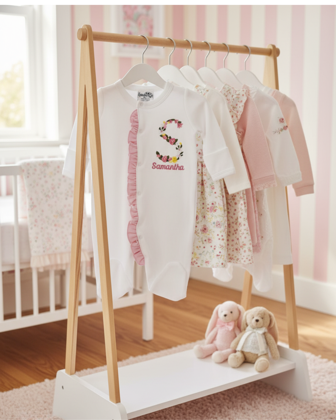 Children's clothing rack with baby clothes and stuffed toys in a nursery setting