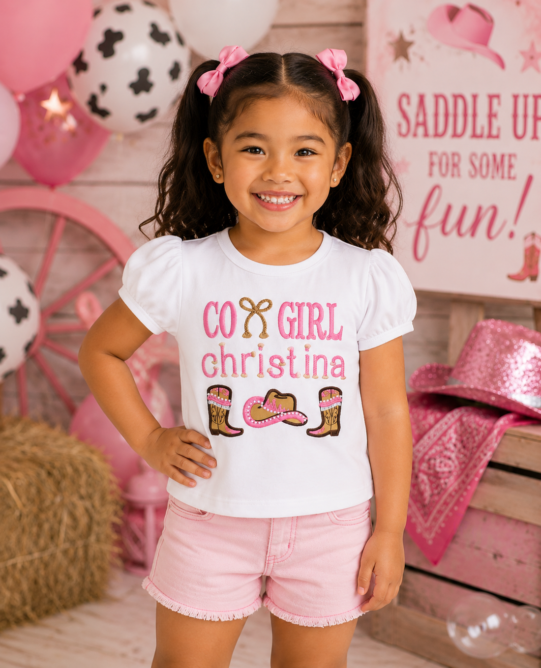 Girl wearing a personalized embroidered cowgirl birthday shirt featuring western boots, cowboy hat, rope detail, and custom embroidered name at a western birthday party by RoJo Custom Designs.