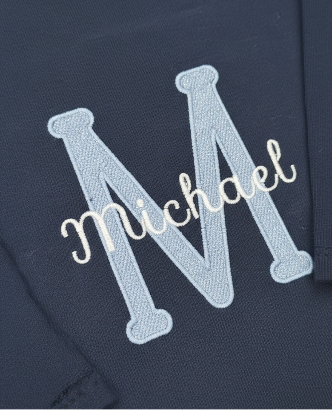 Embroidered name 'Michael' on a dark fabric background