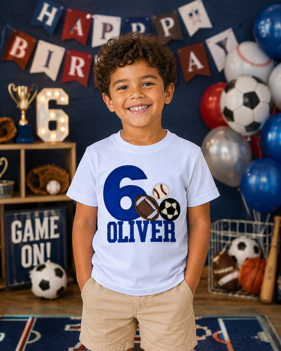 Personalized embroidered all sports birthday shirt for boys featuring a blue number 6 with baseball, football, soccer ball, and custom embroidered name Oliver on a white 100% cotton shirt. | RoJo Custom Designs