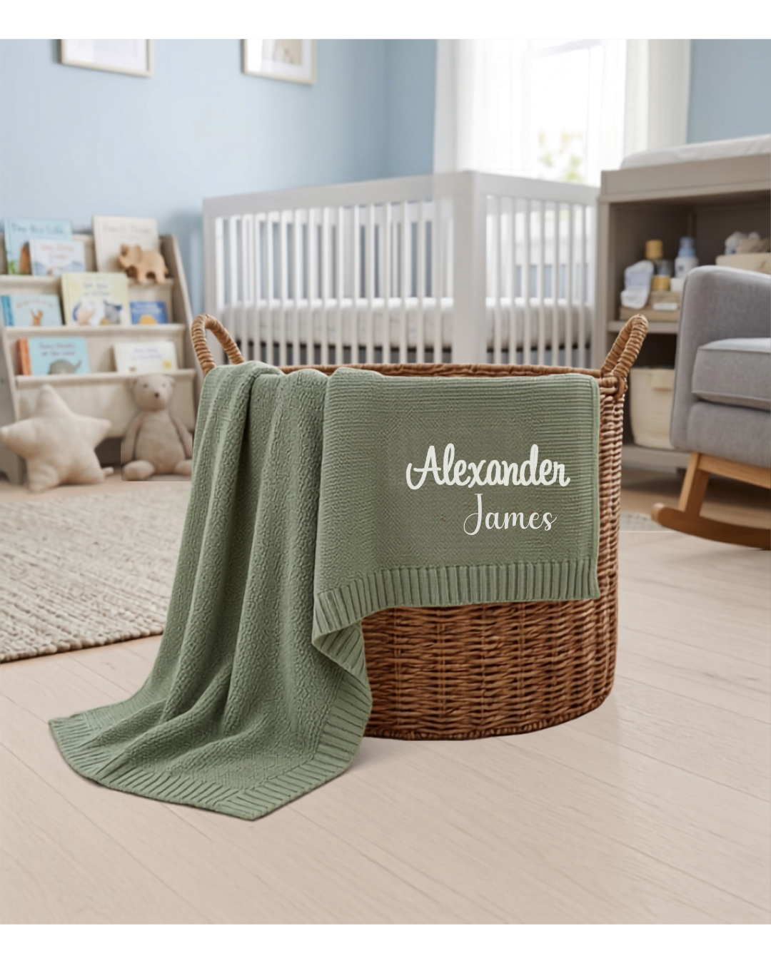 Sage green personalized knit baby blanket with custom embroidered name displayed in nursery