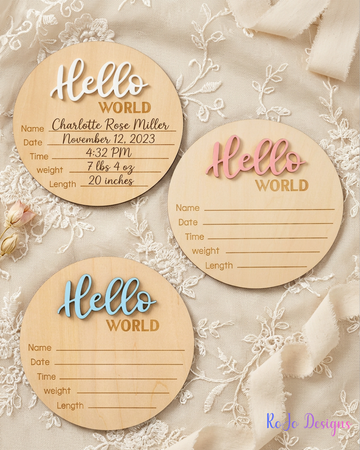 Wooden Hello World birth announcement signs available in blue, pink, and white lettering